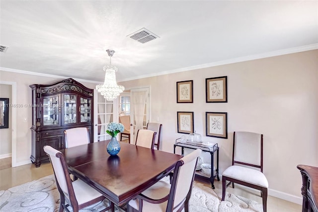 dining room with visible vents and crown molding