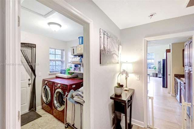 clothes washing area featuring laundry area, visible vents, independent washer and dryer, and light tile patterned floors