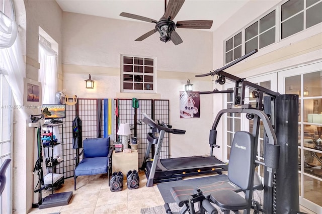 exercise area with tile patterned flooring and a ceiling fan