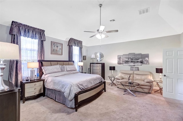 bedroom with light carpet, ceiling fan, visible vents, and lofted ceiling