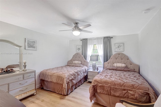 bedroom featuring a ceiling fan and light wood-type flooring