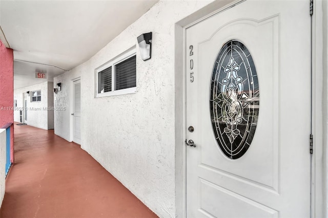 doorway to property with stucco siding