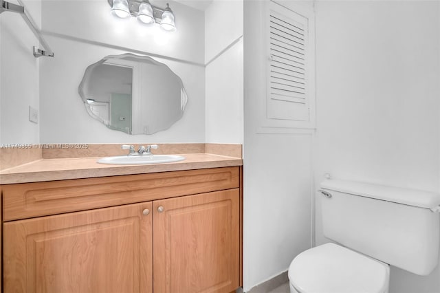 bathroom with toilet and vanity