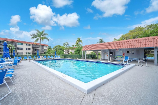 pool with fence and a patio