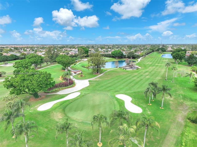 birds eye view of property featuring golf course view and a water view