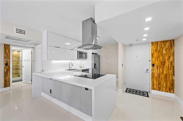 kitchen featuring a peninsula, white cabinetry, light countertops, modern cabinets, and island exhaust hood