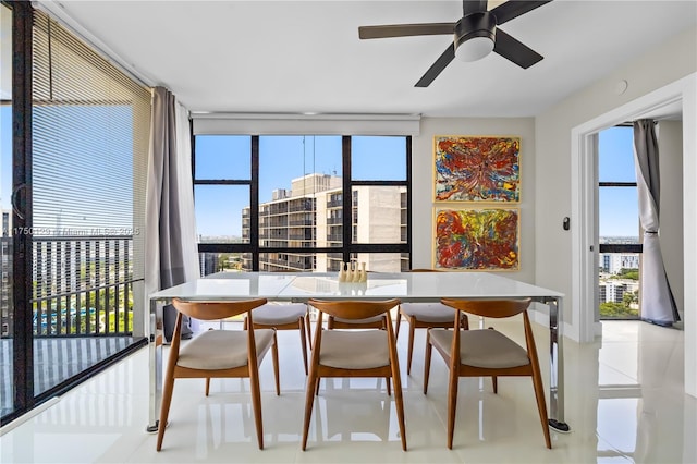 dining room featuring a ceiling fan and a city view