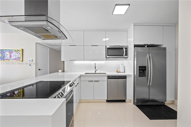 kitchen featuring stainless steel appliances, light countertops, white cabinets, and a sink