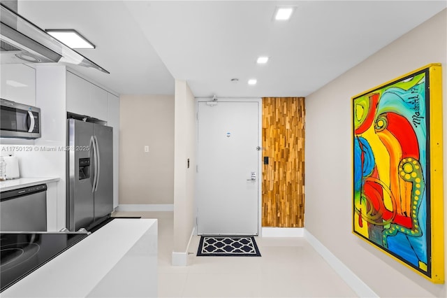 kitchen with modern cabinets, stainless steel appliances, light countertops, white cabinetry, and recessed lighting