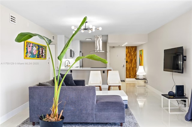 living area featuring a chandelier, light tile patterned floors, visible vents, and baseboards