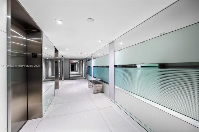 hallway featuring light tile patterned floors and recessed lighting