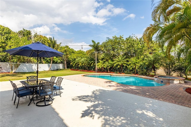 view of swimming pool featuring a yard, a patio area, a fenced backyard, and a pool with connected hot tub