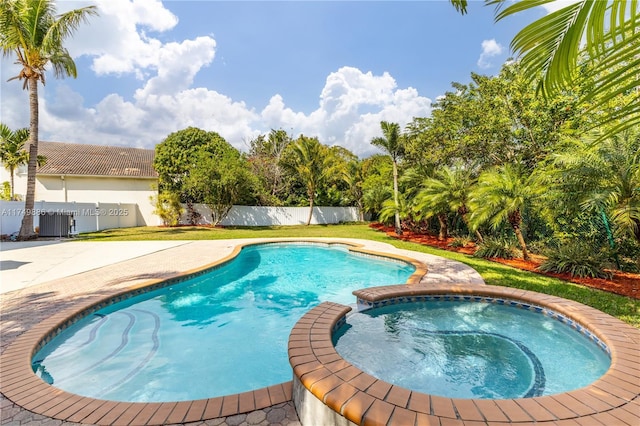 view of swimming pool with central air condition unit, a fenced backyard, and a pool with connected hot tub