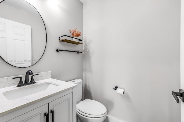 bathroom featuring vanity and toilet