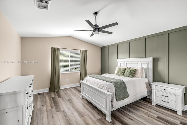 bedroom with lofted ceiling, ceiling fan, light wood finished floors, and visible vents