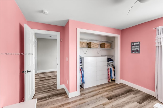 mudroom with light wood-style flooring and baseboards