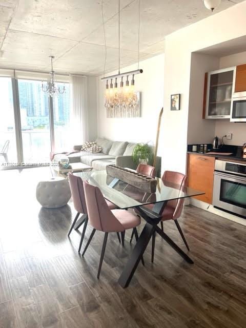 dining room featuring dark wood-style floors and a notable chandelier