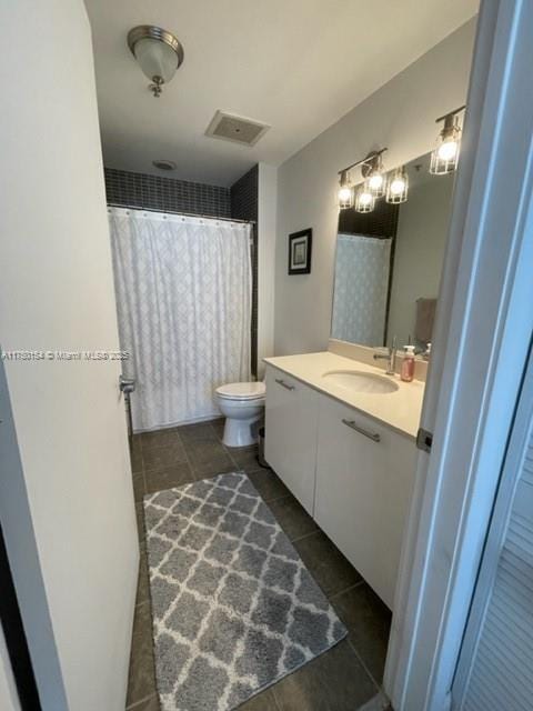 bathroom featuring tile patterned flooring, toilet, visible vents, vanity, and a shower with curtain