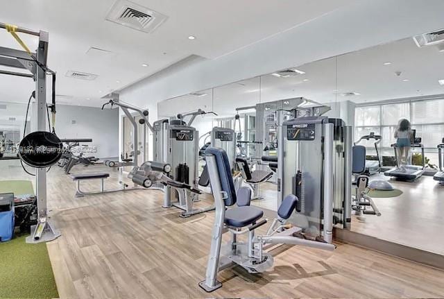 gym featuring visible vents and light wood-style floors