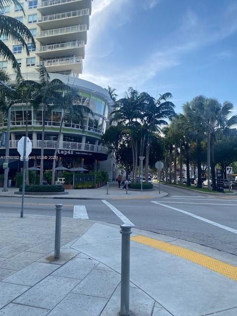 exterior space with curbs, traffic signs, and sidewalks