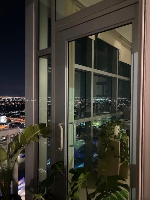 balcony at twilight featuring a view of city lights