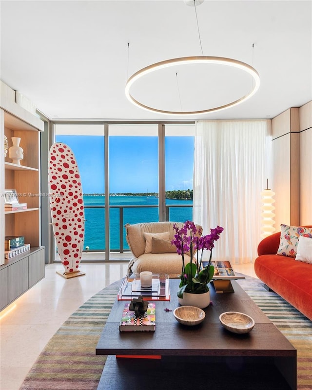 living area featuring a water view and floor to ceiling windows