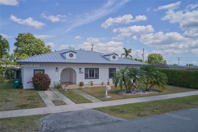 10745 Westwood Lake Dr, Miami, FL 33165 - view of front of property featuring a standing seam roof, stucco siding, a metal roof, and a front lawn