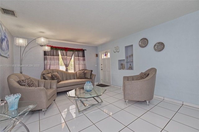 living room with light tile patterned floors and visible vents