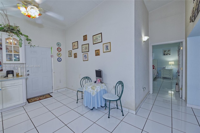 foyer entrance featuring light tile patterned flooring and a ceiling fan