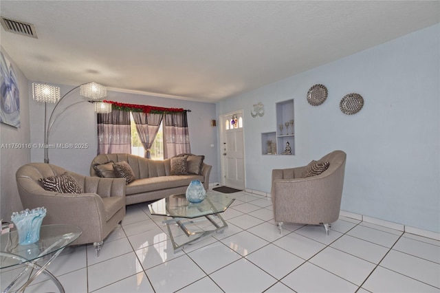 living area featuring visible vents and light tile patterned floors