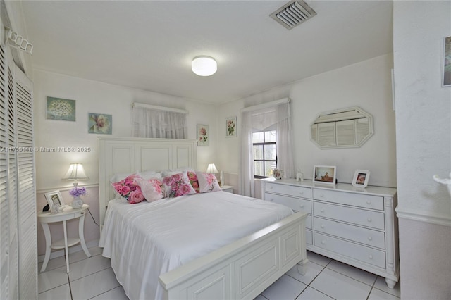 bedroom featuring visible vents and light tile patterned floors