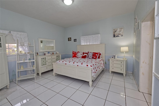 bedroom featuring light tile patterned floors