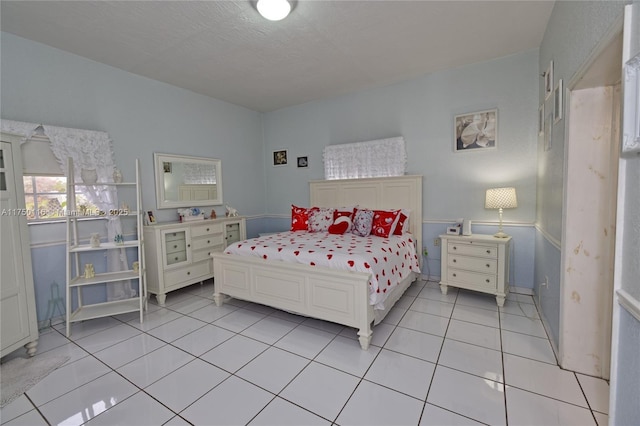 bedroom featuring light tile patterned flooring