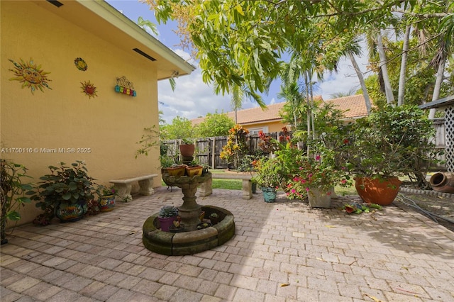 view of patio featuring fence