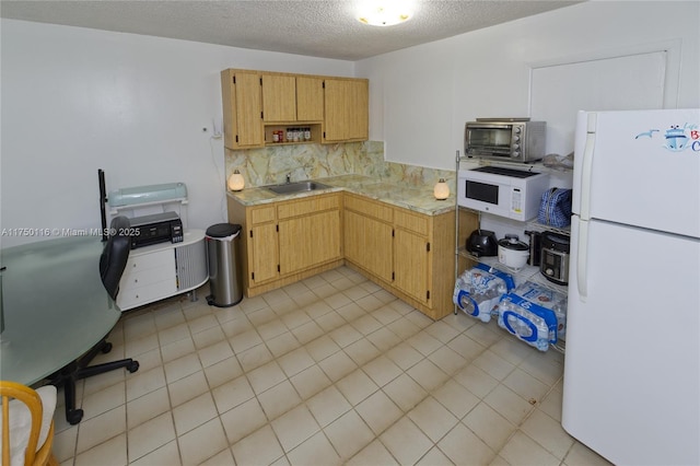 kitchen featuring light countertops, backsplash, a sink, a textured ceiling, and white appliances