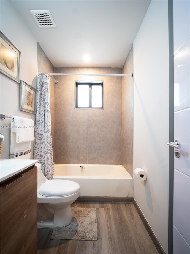 full bath featuring toilet, wood finished floors, vanity, visible vents, and shower / bath combination with curtain