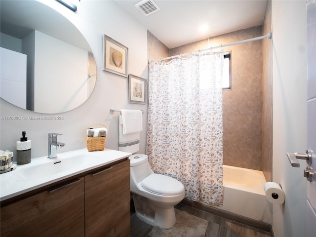 bathroom featuring toilet, wood finished floors, vanity, and visible vents