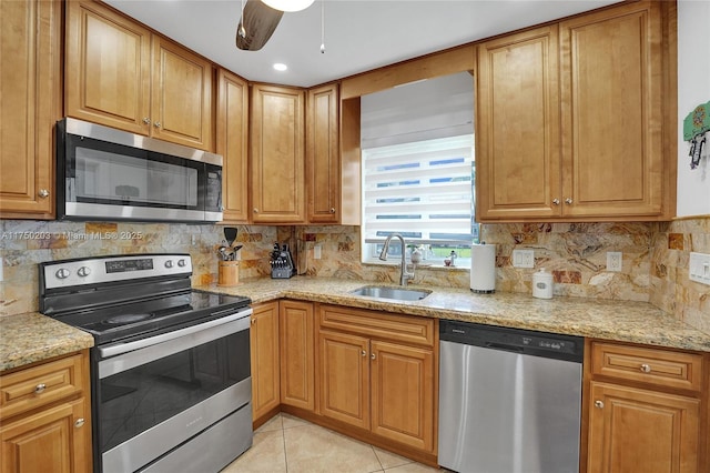 5300 Washington St Unit I203, Hollywood, FL 33021 - kitchen with light stone countertops, appliances with stainless steel finishes, decorative backsplash, and a sink