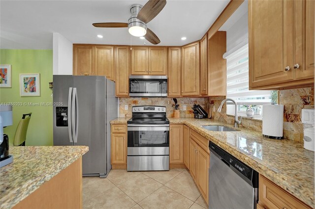 5300 Washington St Unit I203, Hollywood, FL 33021 - kitchen with light stone counters, appliances with stainless steel finishes, backsplash, a sink, and light tile patterned flooring