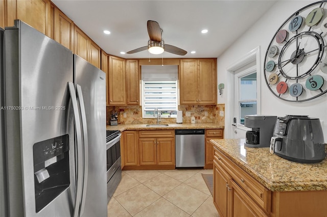 5300 Washington St Unit I203, Hollywood, FL 33021 - kitchen featuring decorative backsplash, light tile patterned floors, stainless steel appliances, ceiling fan, and a sink
