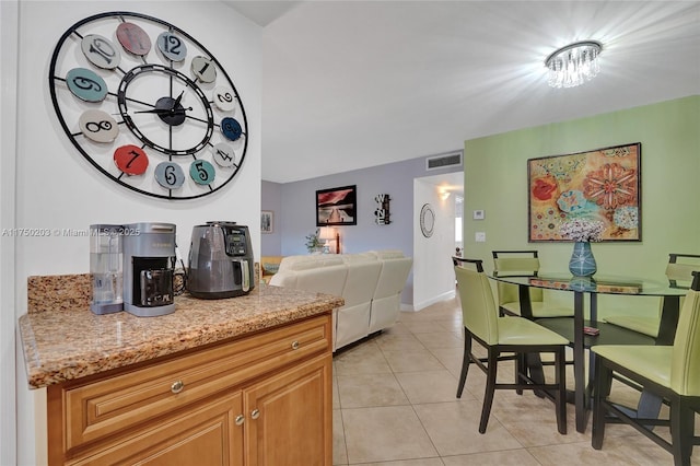 5300 Washington St Unit I203, Hollywood, FL 33021 - kitchen featuring light stone counters, light tile patterned floors, visible vents, baseboards, and open floor plan