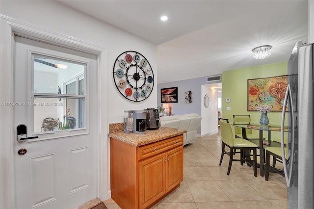 5300 Washington St Unit I203, Hollywood, FL 33021 - interior space with baseboards, visible vents, light tile patterned floors, and stainless steel fridge