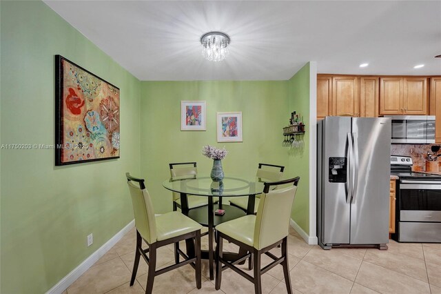 5300 Washington St Unit I203, Hollywood, FL 33021 - dining room with light tile patterned floors, recessed lighting, an inviting chandelier, and baseboards