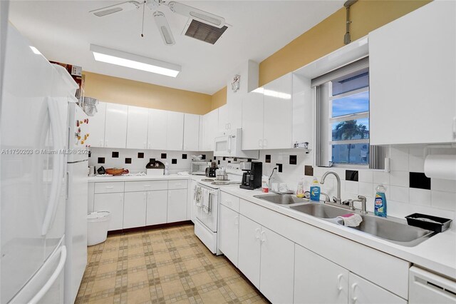 5300 Washington St Unit I203, Hollywood, FL 33021 - kitchen with white appliances, decorative backsplash, light countertops, ceiling fan, and visible vents