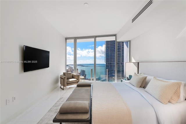 bedroom featuring access to exterior, floor to ceiling windows, and visible vents