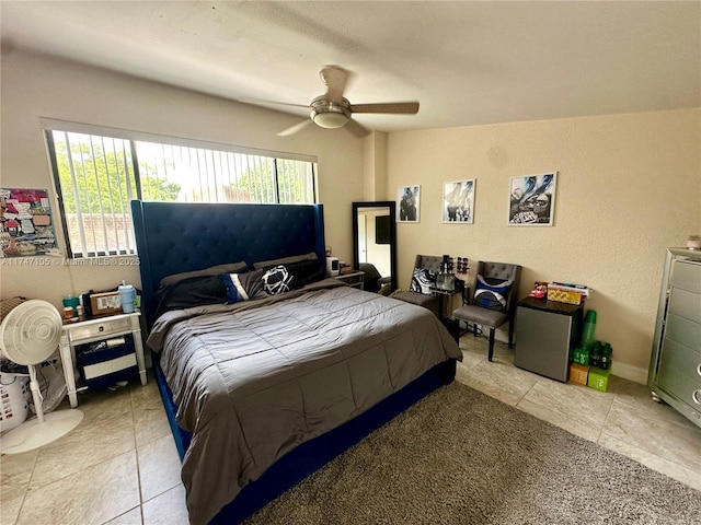 bedroom featuring light tile patterned flooring, a ceiling fan, and baseboards