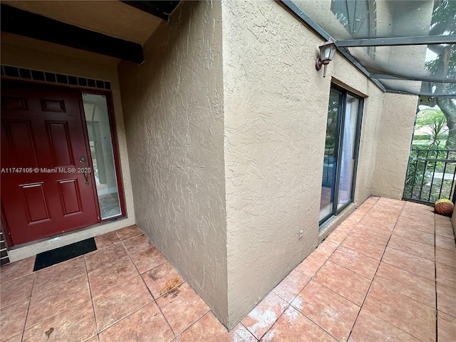 entrance to property featuring stucco siding