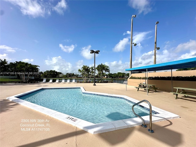 pool featuring a patio area and fence