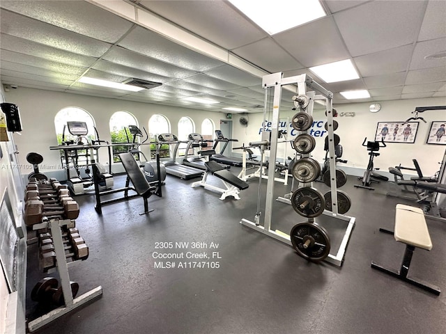 workout area featuring visible vents and a paneled ceiling