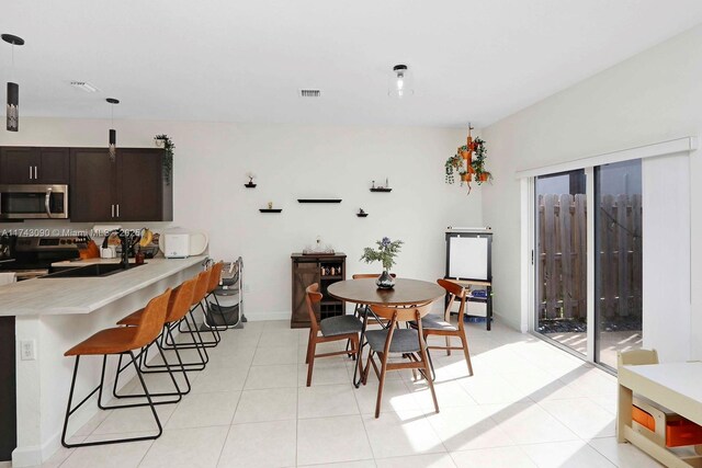 dining area with visible vents, baseboards, and light tile patterned flooring